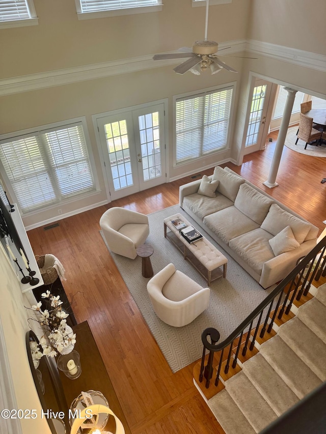280 Green Forest Cir, Dunn, NC 28334 - living room featuring a towering ceiling, plenty of natural light, wood finished floors, a ceiling fan, and decorative columns