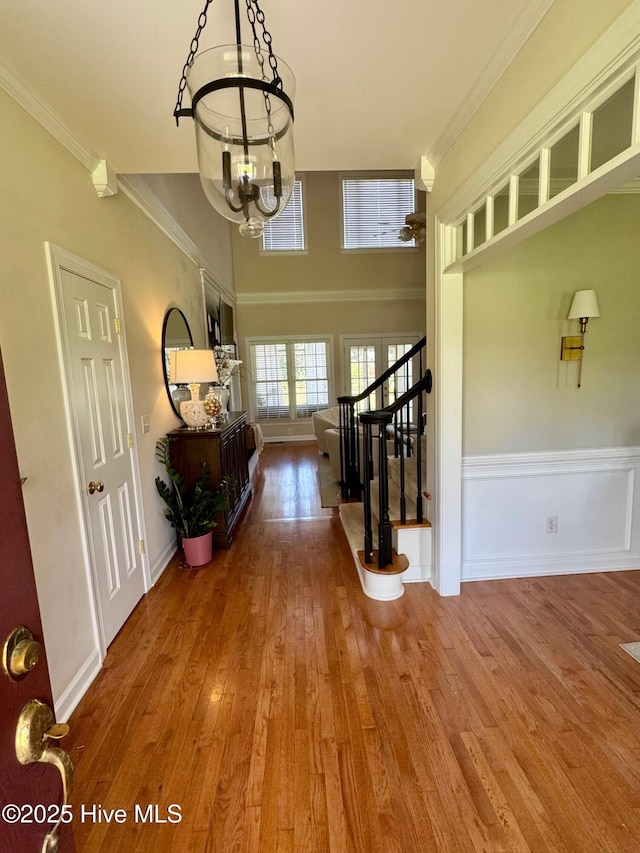 280 Green Forest Cir, Dunn, NC 28334 - foyer entrance with a chandelier, wood finished floors, stairs, crown molding, and a ceiling fan