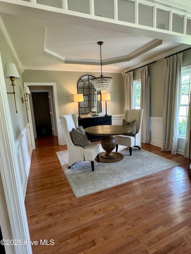 280 Green Forest Cir, Dunn, NC 28334 - dining space featuring ornamental molding, wood finished floors, a tray ceiling, a wainscoted wall, and a decorative wall