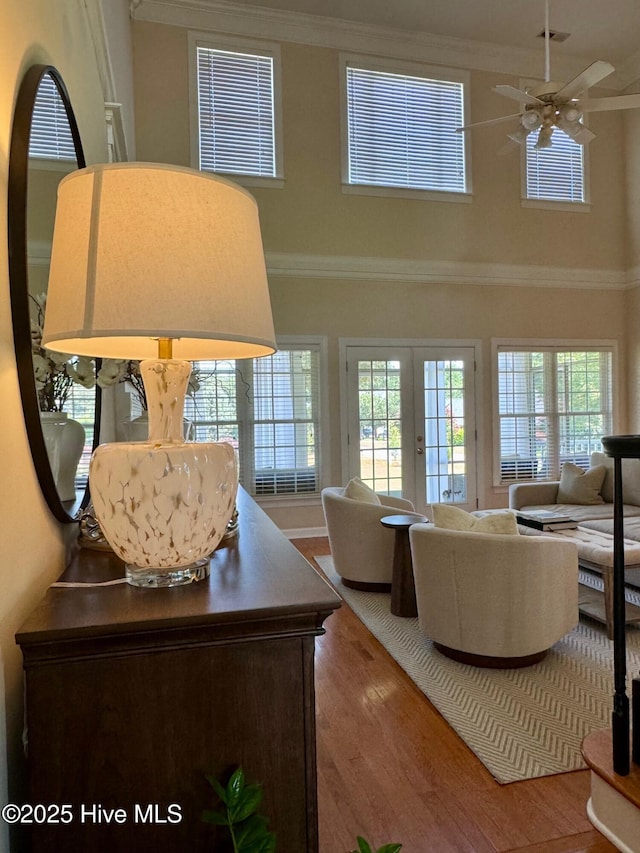 280 Green Forest Cir, Dunn, NC 28334 - living area featuring a high ceiling, crown molding, wood finished floors, ceiling fan, and french doors