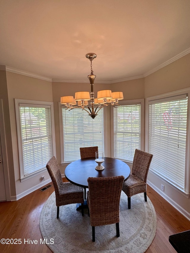 280 Green Forest Cir, Dunn, NC 28334 - dining area with a chandelier, wood finished floors, and crown molding