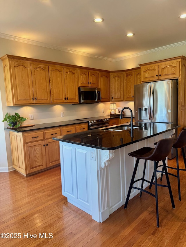 280 Green Forest Cir, Dunn, NC 28334 - kitchen featuring stainless steel appliances, ornamental molding, a breakfast bar, a center island with sink, and light wood-type flooring