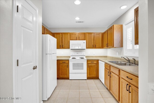 111 Yaupon Ct, Hampstead, NC 28443 - kitchen featuring white appliances, light countertops, recessed lighting, light tile patterned floors, and brown cabinetry