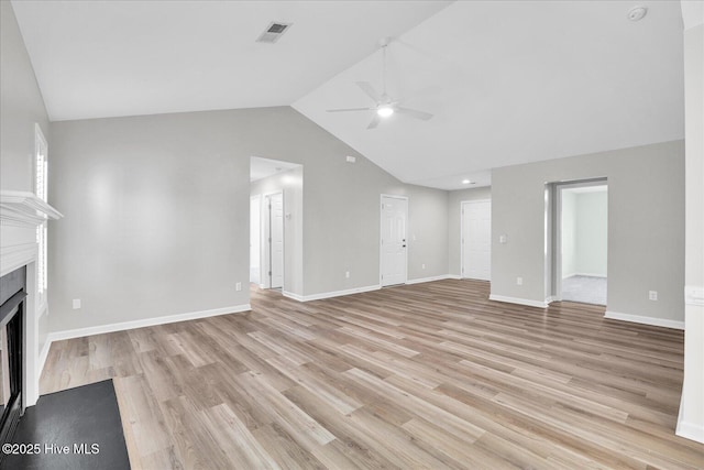 111 Yaupon Ct, Hampstead, NC 28443 - unfurnished living room with ceiling fan, a fireplace, light wood-style flooring, and high vaulted ceiling