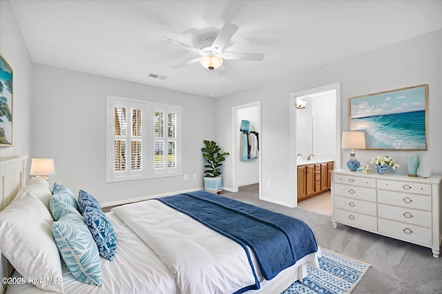 111 Yaupon Ct, Hampstead, NC 28443 - bedroom featuring light colored carpet, ceiling fan, a spacious closet, and ensuite bath