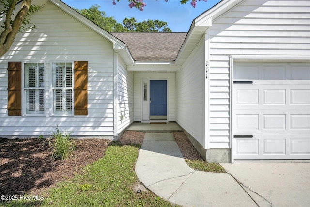 111 Yaupon Ct, Hampstead, NC 28443 - view of exterior entry with an attached garage and roof with shingles