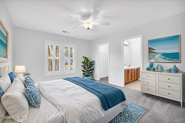 111 Yaupon Ct, Hampstead, NC 28443 - bedroom featuring light carpet, a spacious closet, ceiling fan, ensuite bathroom, and a closet
