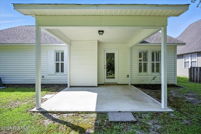 111 Yaupon Ct, Hampstead, NC 28443 - view of exterior entry featuring a shingled roof and a patio