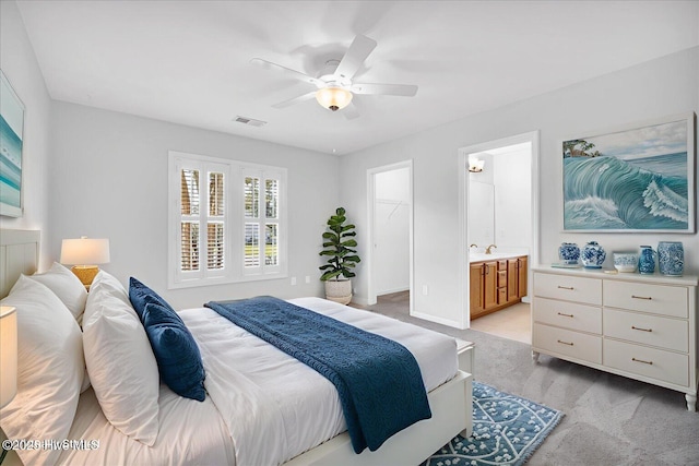 111 Yaupon Ct, Hampstead, NC 28443 - bedroom featuring light carpet, a spacious closet, ceiling fan, and ensuite bath