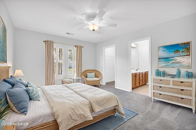111 Yaupon Ct, Hampstead, NC 28443 - bedroom featuring light colored carpet, a spacious closet, ceiling fan, ensuite bathroom, and a closet