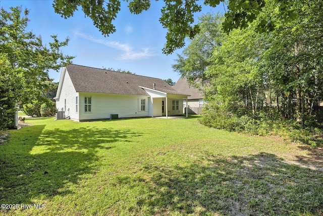 111 Yaupon Ct, Hampstead, NC 28443 - back of property with a lawn, a patio area, and a shingled roof