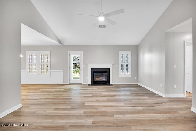 111 Yaupon Ct, Hampstead, NC 28443 - unfurnished living room featuring ceiling fan, light wood finished floors, a fireplace with flush hearth, and high vaulted ceiling