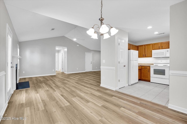 111 Yaupon Ct, Hampstead, NC 28443 - kitchen featuring white appliances, a chandelier, light countertops, light wood finished floors, and vaulted ceiling