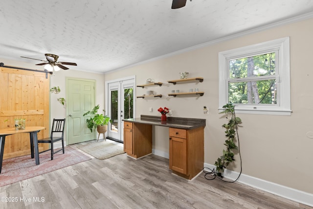 202 Regalwood Dr, Jacksonville, NC 28546 - kitchen with ceiling fan, light wood finished floors, brown cabinetry, open shelves, and ornamental molding