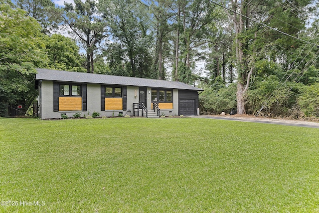 202 Regalwood Dr, Jacksonville, NC 28546 - view of front of property with driveway, a front yard, brick siding, a garage, and roof with shingles