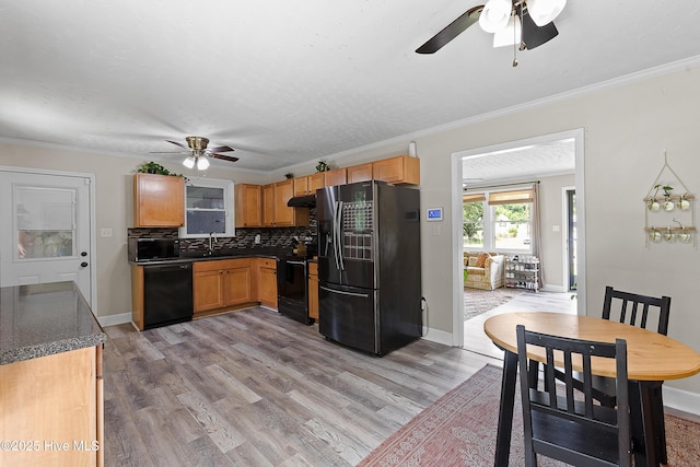 202 Regalwood Dr, Jacksonville, NC 28546 - kitchen featuring black appliances, ceiling fan, dark countertops, under cabinet range hood, and tasteful backsplash