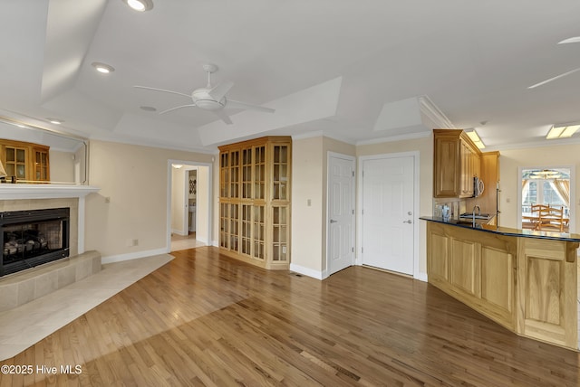 240 Drake Lndg, New Bern, NC 28560 - unfurnished living room with a tray ceiling, crown molding, ceiling fan, recessed lighting, and wood finished floors