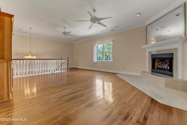 240 Drake Lndg, New Bern, NC 28560 - unfurnished living room with crown molding, light wood-type flooring, a chandelier, a ceiling fan, and a tile fireplace