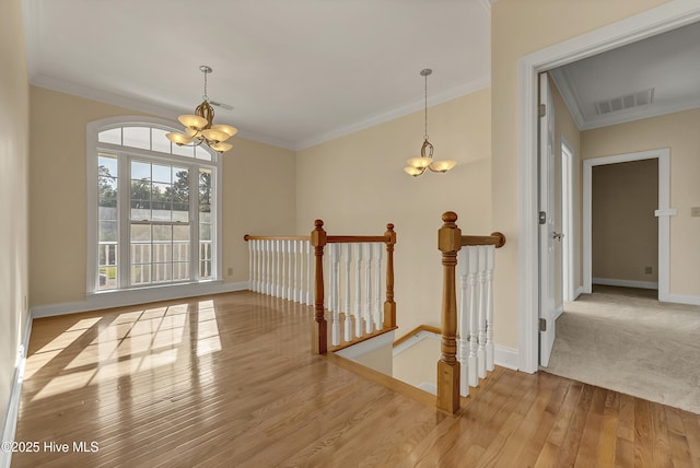 240 Drake Lndg, New Bern, NC 28560 - hallway featuring a chandelier, an upstairs landing, wood finished floors, and crown molding