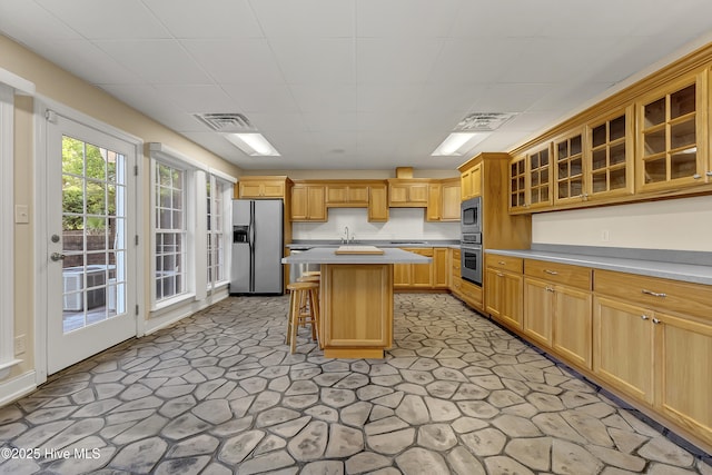 240 Drake Lndg, New Bern, NC 28560 - kitchen featuring stainless steel appliances, a kitchen breakfast bar, light countertops, glass insert cabinets, and a paneled ceiling