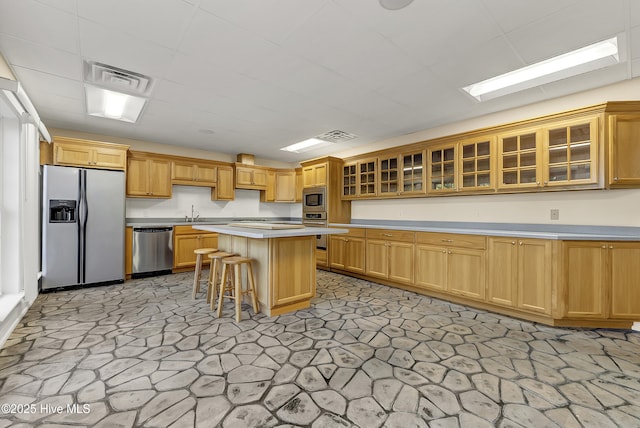 240 Drake Lndg, New Bern, NC 28560 - kitchen featuring stainless steel appliances, light countertops, a kitchen breakfast bar, a kitchen island, and glass insert cabinets