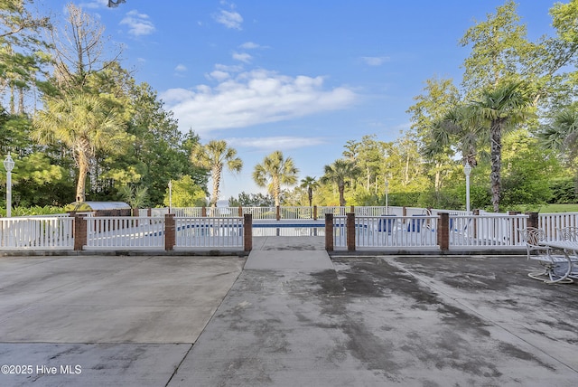 240 Drake Lndg, New Bern, NC 28560 - gate featuring a pool, view of scattered trees, and a patio