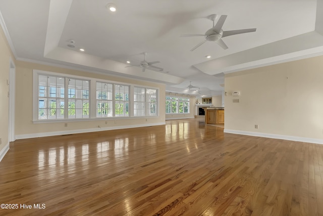 240 Drake Lndg, New Bern, NC 28560 - unfurnished living room with ceiling fan, light wood finished floors, recessed lighting, a raised ceiling, and ornamental molding