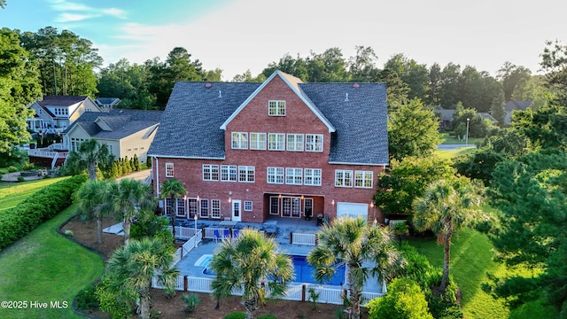 240 Drake Lndg, New Bern, NC 28560 - rear view of property with brick siding, a patio area, a covered pool, view of scattered trees, and french doors