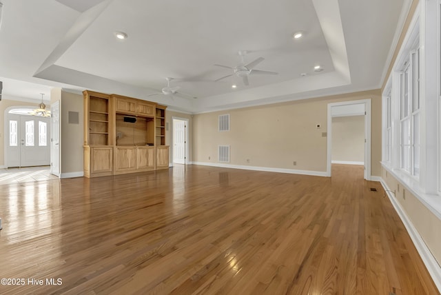 240 Drake Lndg, New Bern, NC 28560 - unfurnished living room with a tray ceiling, ceiling fan, light wood-style flooring, and recessed lighting
