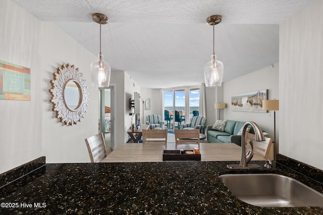 2000 New River Inlet Rd Unit 3513, North Topsail Beach, NC 28460 - kitchen featuring open floor plan, decorative light fixtures, and a textured ceiling