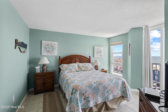 2000 New River Inlet Rd Unit 3513, North Topsail Beach, NC 28460 - bedroom featuring a textured ceiling and light tile patterned floors