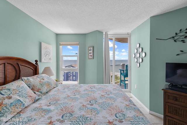 2000 New River Inlet Rd Unit 3513, North Topsail Beach, NC 28460 - tiled bedroom with access to exterior and a textured ceiling