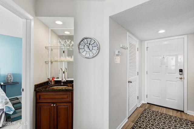 2000 New River Inlet Rd Unit 3513, North Topsail Beach, NC 28460 - entrance foyer featuring bar with sink, wood finished floors, recessed lighting, and a textured ceiling