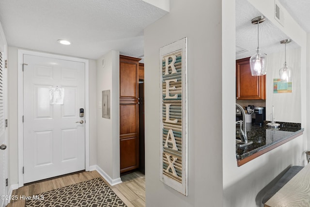 2000 New River Inlet Rd Unit 3513, North Topsail Beach, NC 28460 - foyer entrance featuring light wood-style floors, a textured ceiling, and recessed lighting