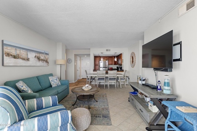 2000 New River Inlet Rd Unit 3513, North Topsail Beach, NC 28460 - living area with a textured ceiling and light tile patterned flooring