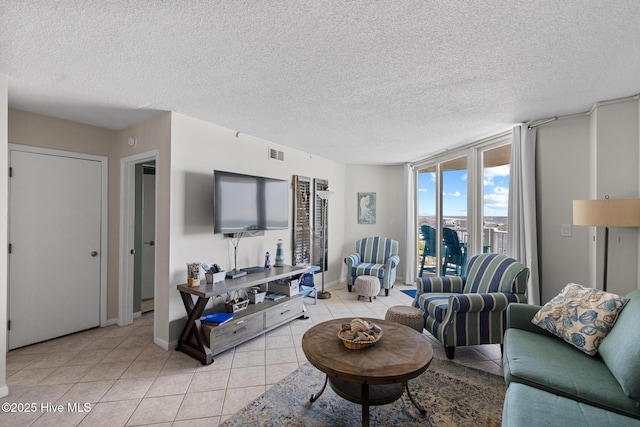 2000 New River Inlet Rd Unit 3513, North Topsail Beach, NC 28460 - living room featuring light tile patterned floors, a textured ceiling, and floor to ceiling windows