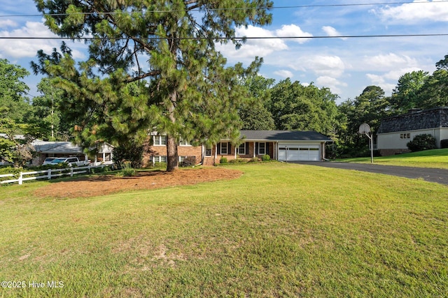 306 Mclean St, Hamlet, NC 28345 - view of front of house featuring asphalt driveway, an attached garage, and brick siding