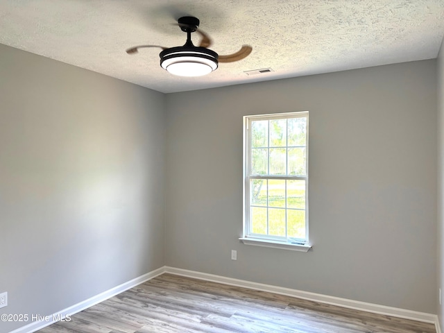 1098 Long Leaf Rd, Southport, NC 28461 - spare room with wood finished floors and a textured ceiling