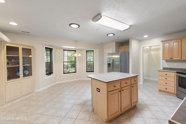 3 Gate 11, Carolina Shores, NC 28467 - kitchen featuring stainless steel appliances, light brown cabinets, a center island, light tile patterned flooring, and hanging light fixtures