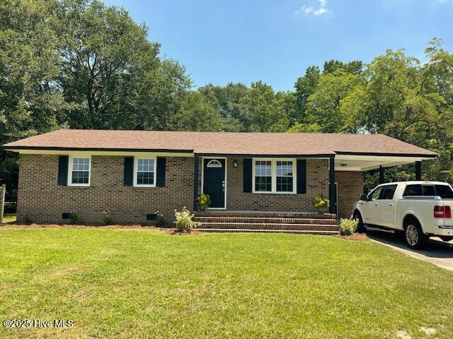 1451 Old Pink Hill Rd, Deep Run, NC 28525 - view of front of home featuring crawl space, brick siding, a front yard, a carport, and concrete driveway