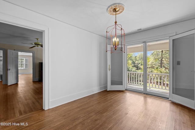 3 Augusta Way, Pinehurst, NC 28374 - empty room featuring wood finished floors, plenty of natural light, and a chandelier