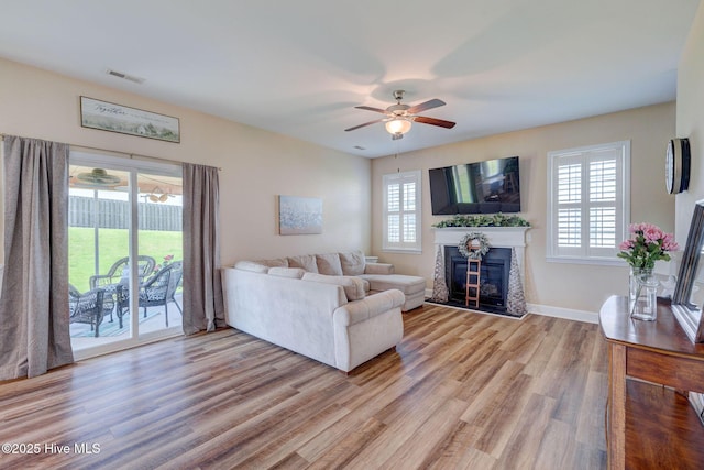 463 Avendale Dr, Rocky Point, NC 28457 - living area featuring a glass covered fireplace, ceiling fan, plenty of natural light, and wood finished floors
