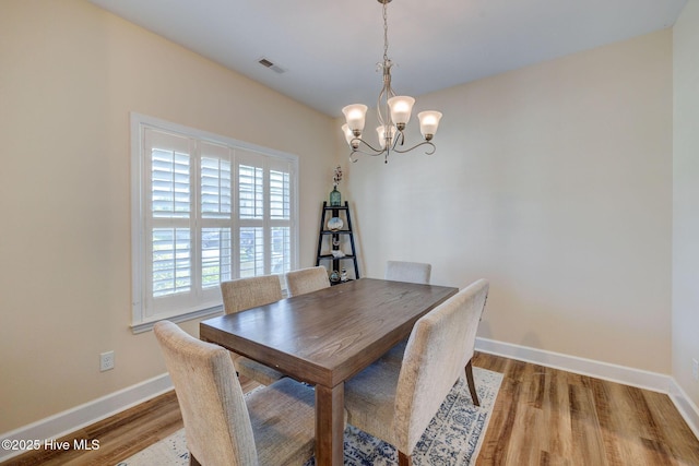 463 Avendale Dr, Rocky Point, NC 28457 - dining area featuring a chandelier and wood finished floors