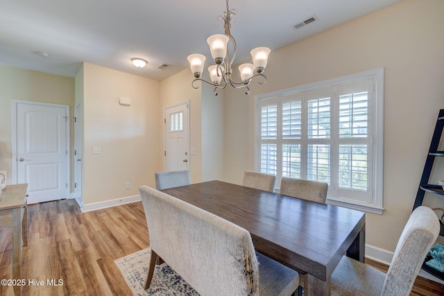 463 Avendale Dr, Rocky Point, NC 28457 - dining room with light wood-style flooring and a chandelier