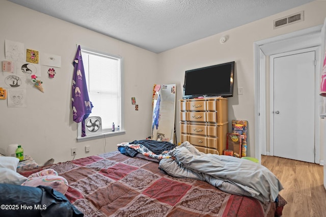 1106 E Stewart Cir, Wilmington, NC 28405 - bedroom featuring wood finished floors and a textured ceiling