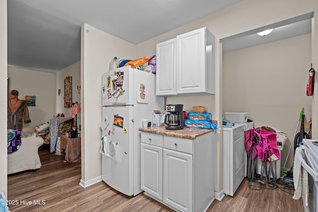 1106 E Stewart Cir, Wilmington, NC 28405 - kitchen featuring freestanding refrigerator, light wood-type flooring, white cabinetry, and light countertops