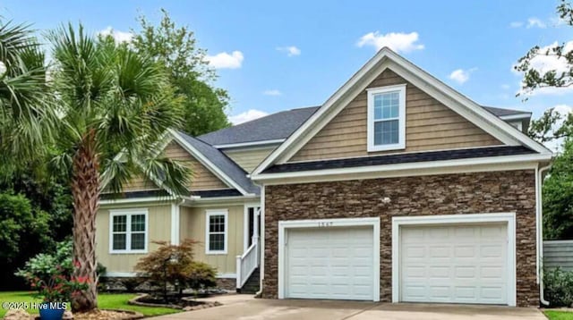 1567 Colonist Sq SW, Ocean Isle Beach, NC 28469 - view of front of home with driveway, board and batten siding, and stone siding