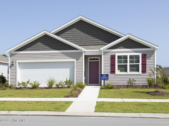 112 Edgewater Way Unit 57, Surf City, NC 28445 - craftsman-style home with an attached garage and a front lawn