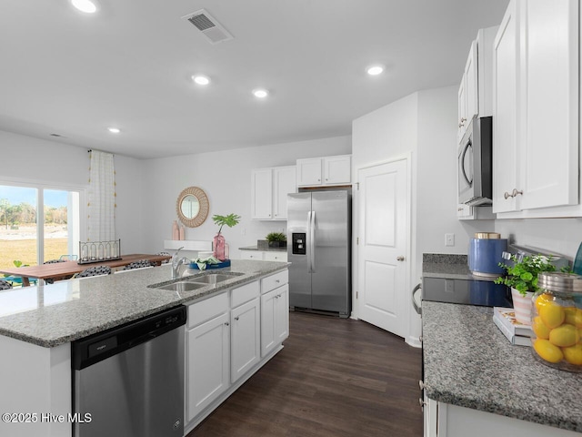 112 Edgewater Way Unit 57, Surf City, NC 28445 - kitchen with appliances with stainless steel finishes, a kitchen island with sink, white cabinets, dark wood-style floors, and recessed lighting