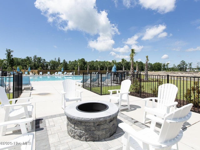 112 Edgewater Way Unit 57, Surf City, NC 28445 - view of patio featuring an outdoor fire pit, a community pool, and view of scattered trees